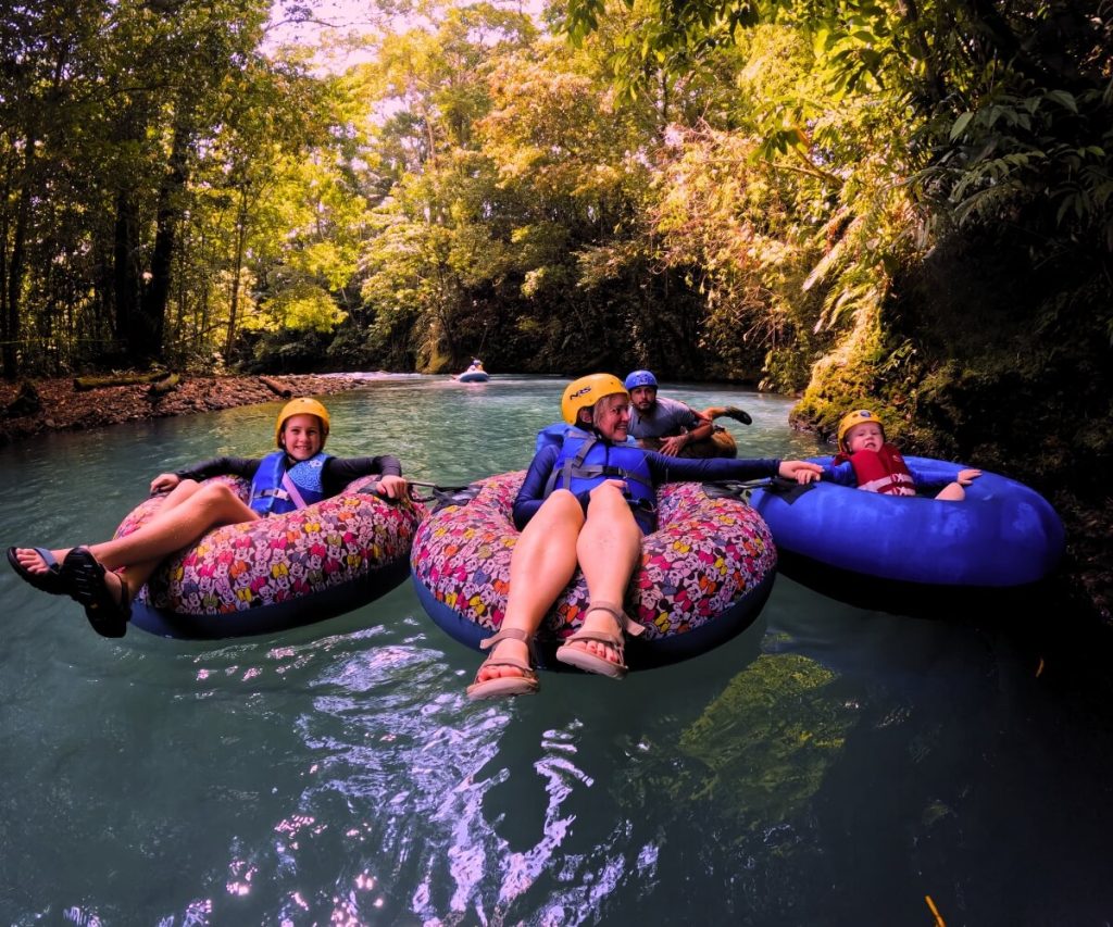 a group of people on inner tubes in a river