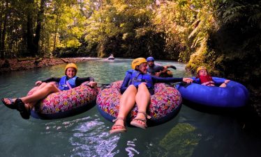 a group of people on inner tubes in a river