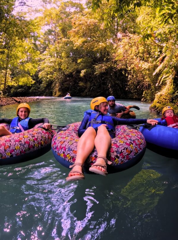 a group of people on inner tubes in a river
