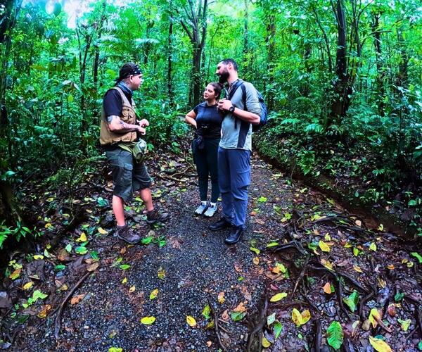a group of people standing in a forest