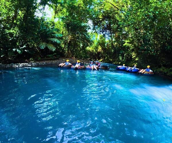 a group of people in rafts in a river