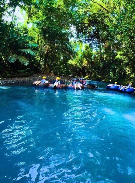a group of people in rafts in a river