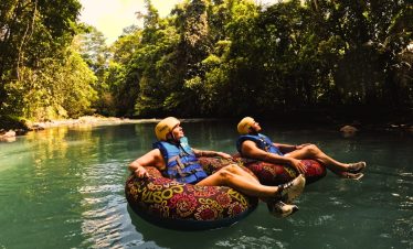 two people floating on inner tubes in a river