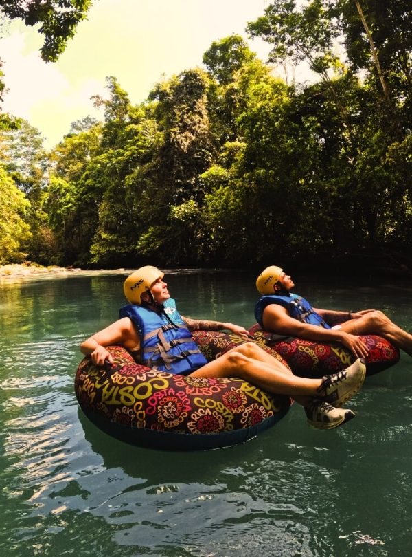 two people floating on inner tubes in a river