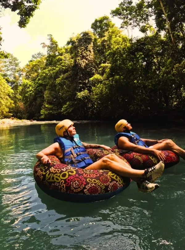 two people floating on inner tubes in a river